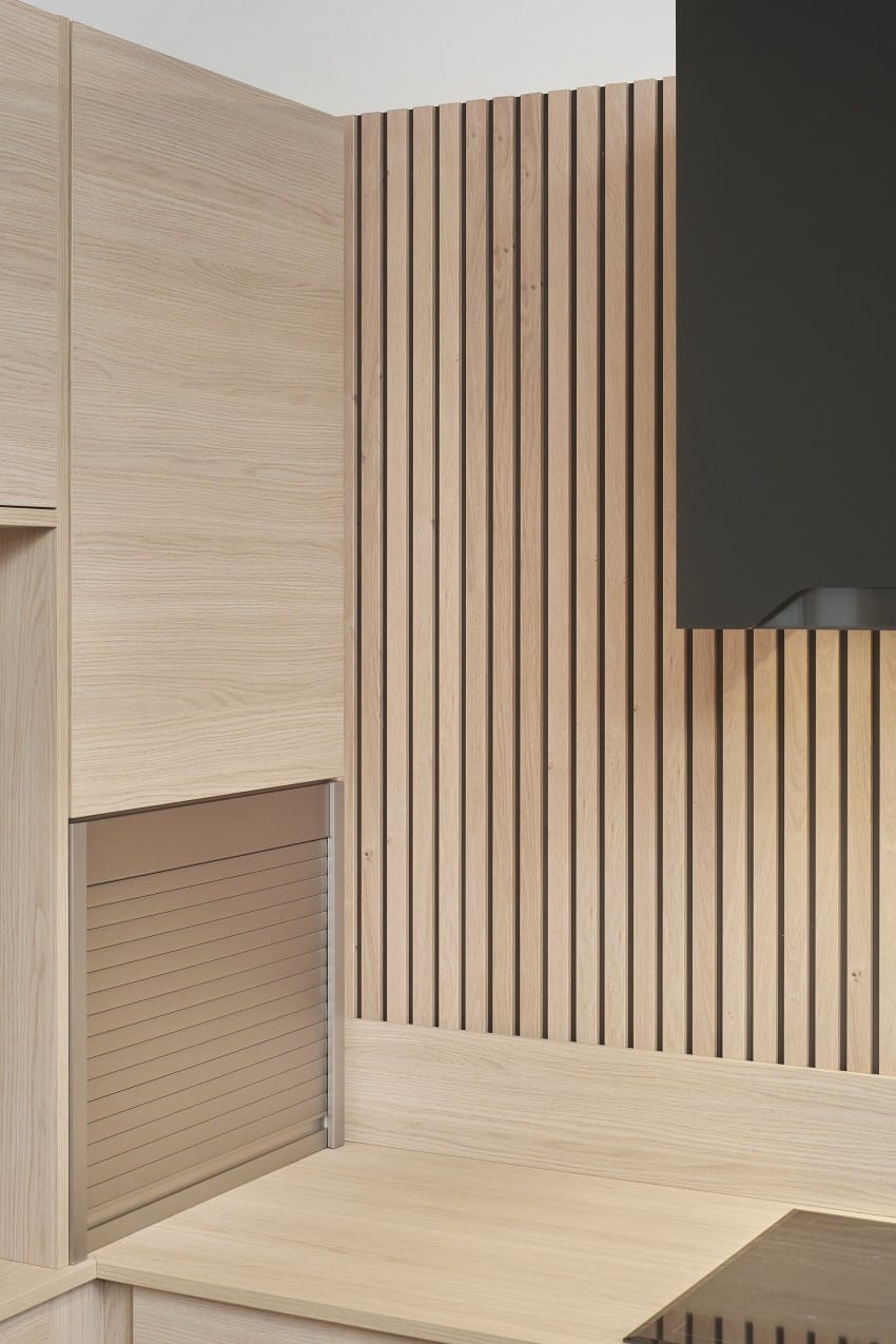 Moderne kjøkken med skap i lyse tre, spaltevegg og sort vifte. Foto: Nathan Lediard, Lediard Foto AS.